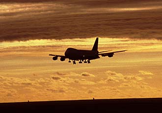 Bali Denpasar airport landing Garuda Indonesia Boeing B747-200 at sunset