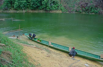 Longtail boat on a river in Sarawak preparing  for departure