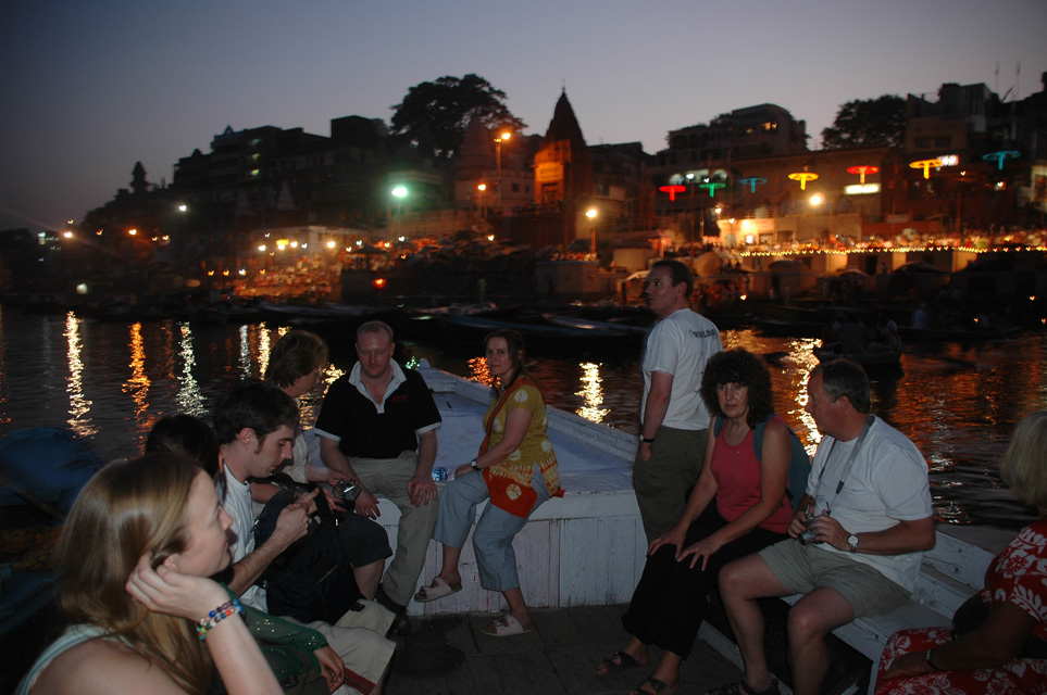 VNS Varanasi or Benares - Dasaswamedh Ghat with a religious ceremony seen from a tourist boat by night 3008x2000